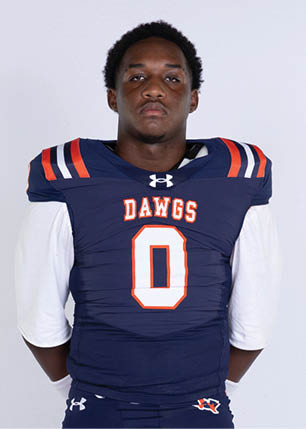 A young man wearing a white and black jersey with the number 14 on it. Description generated by AI