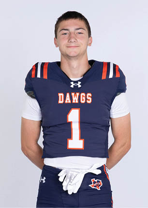 A young man wearing a white and black jersey with the number 14 on it. Description generated by AI