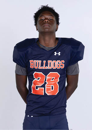 A young man wearing a white and black jersey with the number 14 on it. Description generated by AI