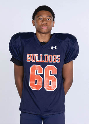 A young man wearing a white and black jersey with the number 14 on it. Description generated by AI
