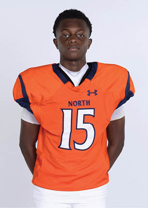 A young man wearing a white and black jersey with the number 14 on it. Description generated by AI