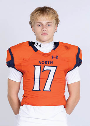 A young man wearing a white and black jersey with the number 14 on it. Description generated by AI