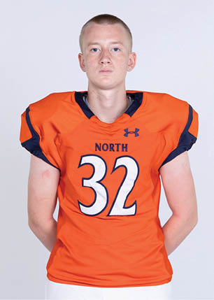 A young man wearing a white and black jersey with the number 14 on it. Description generated by AI