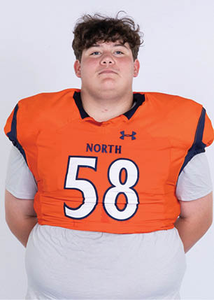 A young man wearing a white and black jersey with the number 14 on it. Description generated by AI