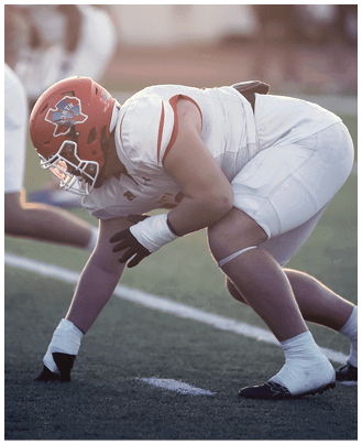 A football player wearing a blue and white uniform. Description generated by AI