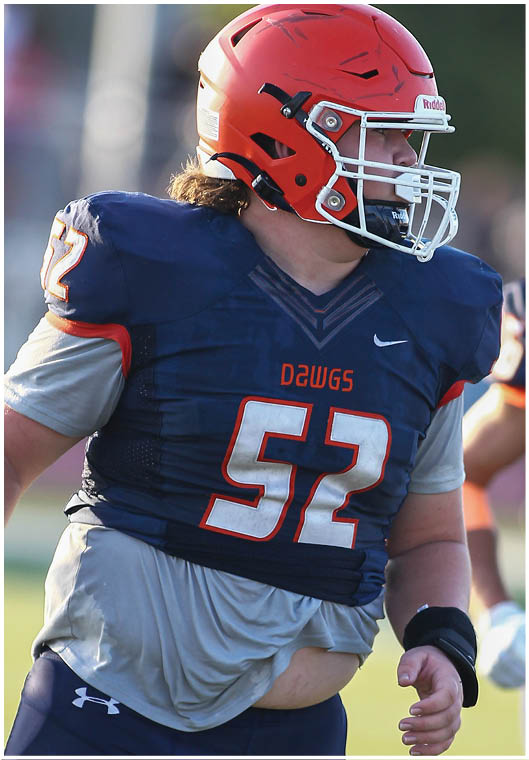 A football player wearing a blue and white uniform. Description generated by AI