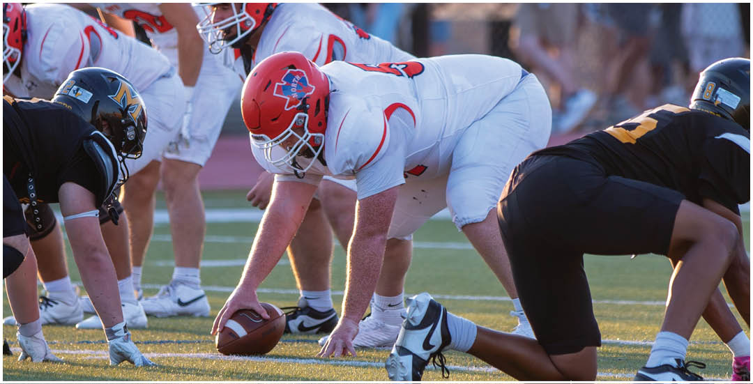 A football player wearing a blue and white uniform. Description generated by AI