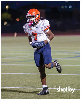 A football player wearing a blue and white uniform. Description generated by AI