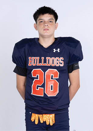 A young man wearing a white and black jersey with the number 14 on it. Description generated by AI