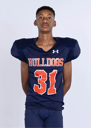 A young man wearing a white and black jersey with the number 14 on it. Description generated by AI