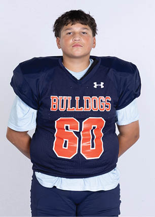 A young man wearing a white and black jersey with the number 14 on it. Description generated by AI