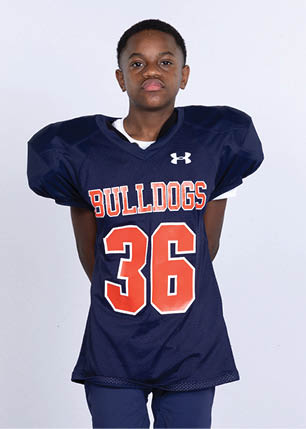 A young man wearing a white and black jersey with the number 14 on it. Description generated by AI
