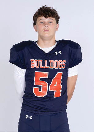 A young man wearing a white and black jersey with the number 14 on it. Description generated by AI