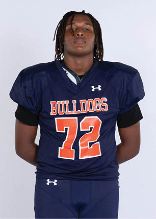 A young man wearing a white and black jersey with the number 14 on it. Description generated by AI