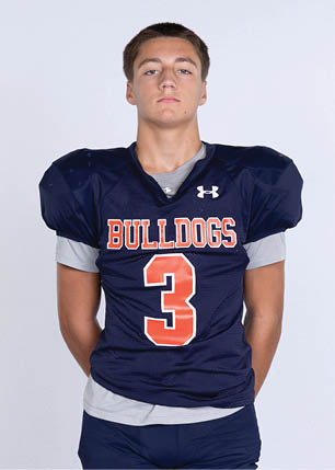 A young man wearing a white and black jersey with the number 14 on it. Description generated by AI