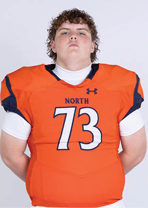 A young man wearing a white and black jersey with the number 14 on it. Description generated by AI