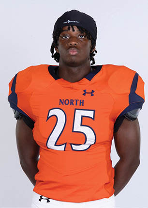 A young man wearing a white and black jersey with the number 14 on it. Description generated by AI