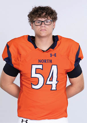 A young man wearing a white and black jersey with the number 14 on it. Description generated by AI