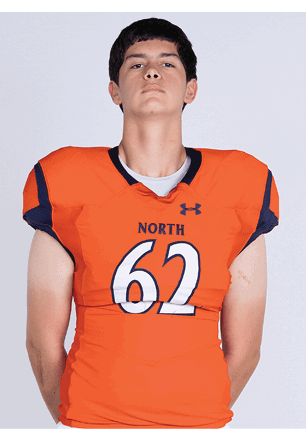 A young man wearing a white and black jersey with the number 14 on it. Description generated by AI