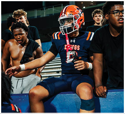 A football player running on the field. Description generated by AI