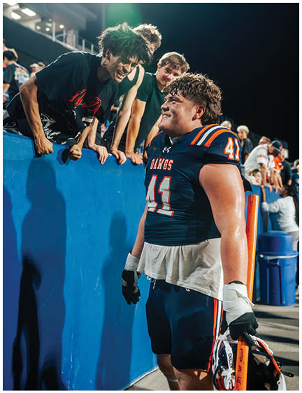 A football player wearing a blue jersey with the number 58 on it. Description generated by AI