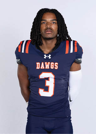 A young man wearing a white and black jersey with the number 14 on it. Description generated by AI