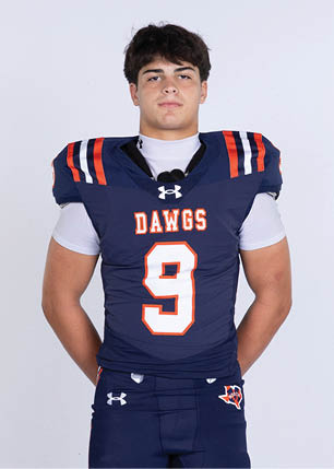 A young man wearing a white and black jersey with the number 14 on it. Description generated by AI