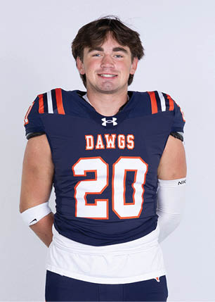 A young man wearing a white and black jersey with the number 14 on it. Description generated by AI