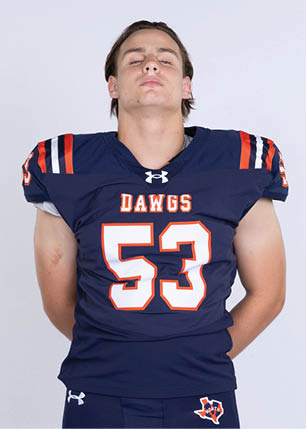 A young man wearing a white and black jersey with the number 14 on it. Description generated by AI