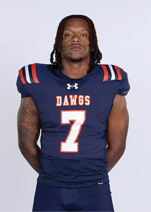 A young man wearing a white and black jersey with the number 14 on it. Description generated by AI