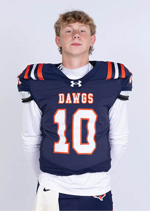 A young man wearing a white and black jersey with the number 14 on it. Description generated by AI