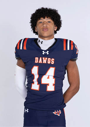 A young man wearing a white and black jersey with the number 14 on it. Description generated by AI