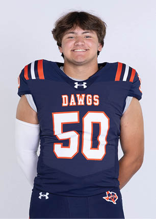 A young man wearing a white and black jersey with the number 14 on it. Description generated by AI