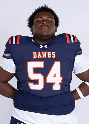 A young man wearing a white and black jersey with the number 14 on it. Description generated by AI