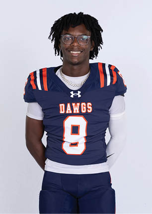 A young man wearing a white and black jersey with the number 14 on it. Description generated by AI