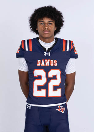 A young man wearing a white and black jersey with the number 14 on it. Description generated by AI