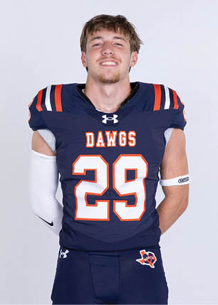 A young man wearing a white and black jersey with the number 14 on it. Description generated by AI