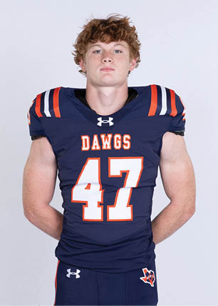 A young man wearing a white and black jersey with the number 14 on it. Description generated by AI