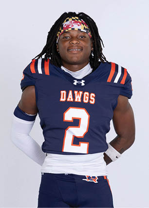 A young man wearing a white and black jersey with the number 14 on it. Description generated by AI