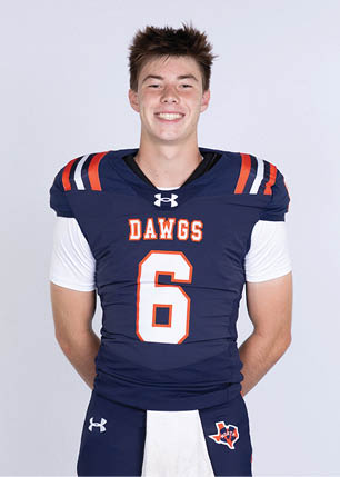 A young man wearing a white and black jersey with the number 14 on it. Description generated by AI