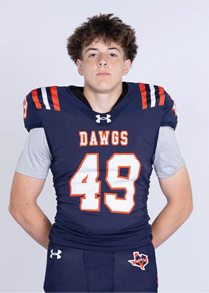 A young man wearing a white and black jersey with the number 14 on it. Description generated by AI
