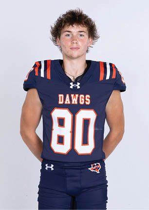 A young man wearing a white and black jersey with the number 14 on it. Description generated by AI