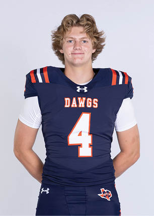 A young man wearing a white and black jersey with the number 14 on it. Description generated by AI