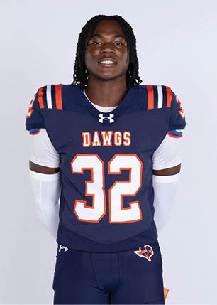 A young man wearing a white and black jersey with the number 14 on it. Description generated by AI