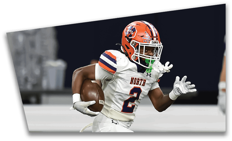 People wearing black American Canyon football uniforms and helmets are standing on a football field at night. Description generated by AI