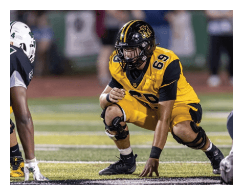 A man wearing a football uniform is jumping to catch a football. AI generated content