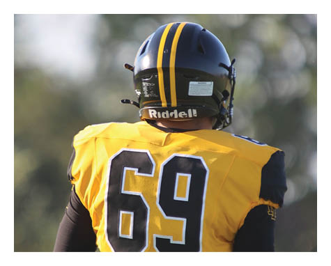 Two football players celebrating a touchdown with one player jumping in the air. AI generated content