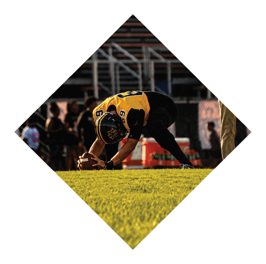 A football player wearing a black jersey with the number 16 on it is holding a football. AI generated content