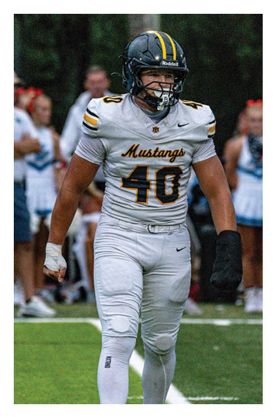 A football player wearing a black and white uniform with the number 10 on the back. AI generated content