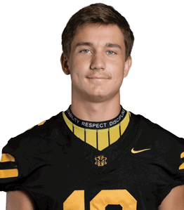A person wearing a black and yellow sports jersey with the number 12 and a collar that reads “ABILITY RESPECT DISCIPLINE" is looking straight ahead with a neutral expression. Description generated by AI